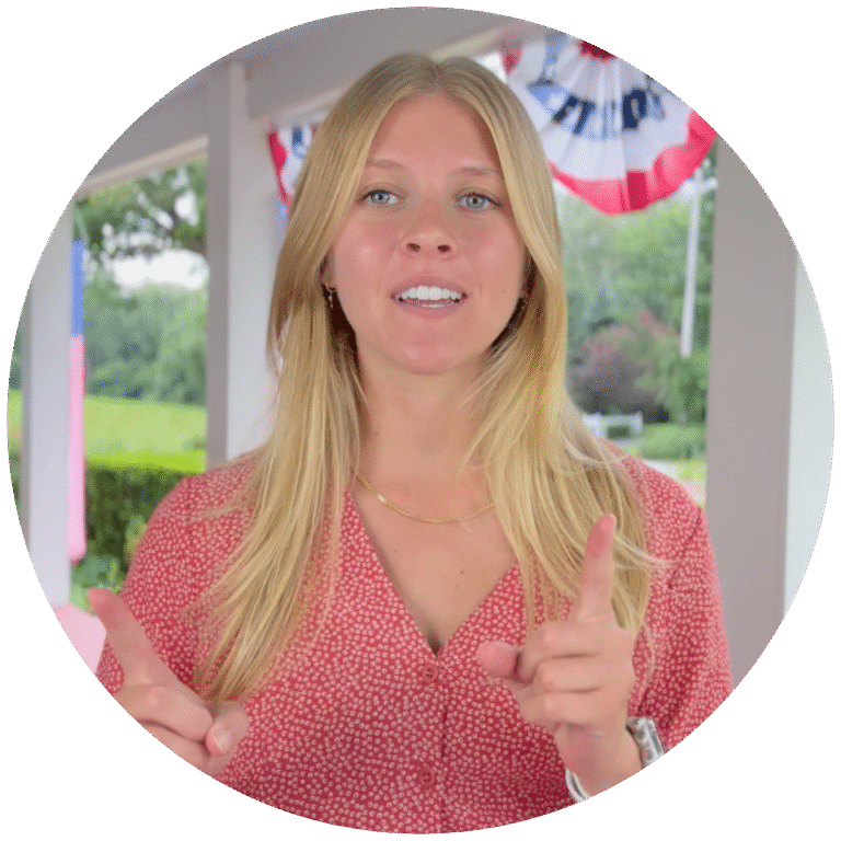 TruVee founder Meghan speaking in front of an American flag backdrop.